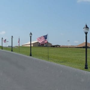 Post top LED lighting illuminates parking lot access 