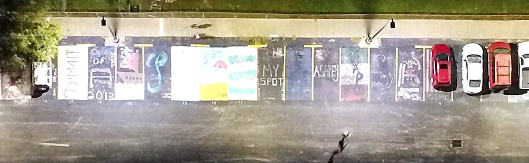 : Parking lot lighting requirements depend on where the parking lot is located. This image is an aerial image of a high school parking lot. 