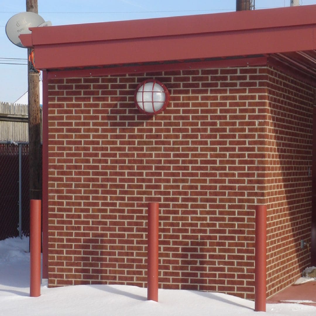 Bulkhead LED wall pack mounted on brick wall